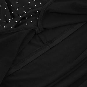 Detailed macro view of black fabric with sparkling rhinestones and neat hem stitching