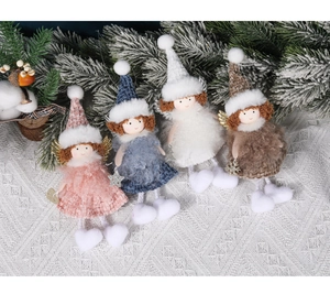 Four plush Christmas angel dolls with gold wings and stars on white lace background
