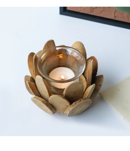 Close-up of handmade driftwood candle holder with wooden petals and a clear glass cup