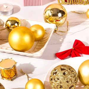 Detailed view of assorted gold Christmas ornaments with glitter and matte finishes