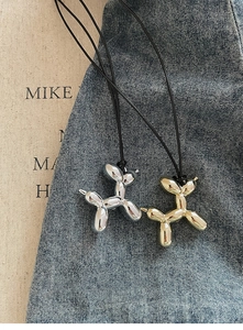 Detail view of silver and gold balloon dog pendants with polished metallic finish