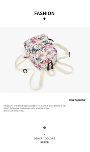 Detail of floral canvas backpack featuring pink and yellow flowers with adjustable straps