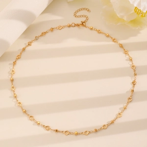 Detailed shot of golden necklace with hollow heart links and adjustable lobster clasp