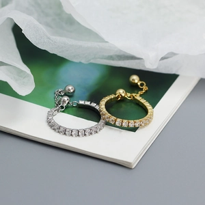 Close-up of gold and silver S925 rings with sparkling square-cut crystals and chain detail