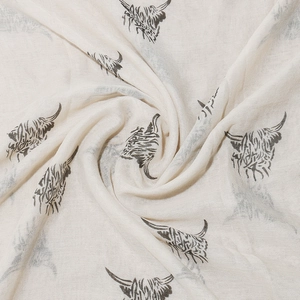 Detailed view of soft beige scarf fabric with realistic grey Highland Cow printed patterns
