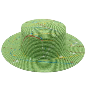 Artistic green straw boater hat with vibrant paint splatter graffiti for street style