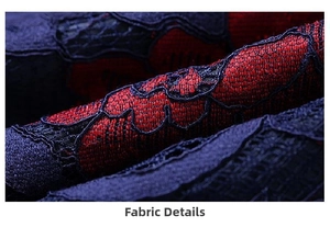 Close-up of vintage red and black lace embroidery fabric with intricate floral patterns