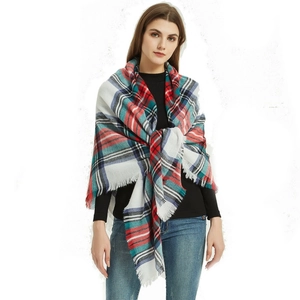 Close-up of red, white, blue and green plaid cashmere-feel scarf with elegant soft tassels