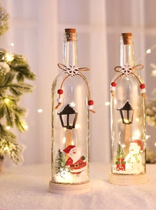 Close-up of LED Christmas glass jars with Santa figurines and warm glowing fairy lights