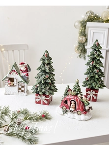 Miniature resin Christmas figurines with snow-covered trees and vintage camper decor