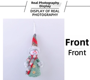 Detailed view of handmade knitted snowman Christmas ornament with red hat and green dress