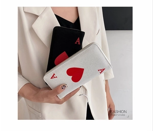 Detail showingAce of Hearts poker card design on slim canvas wallet with zipper closure
