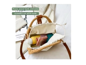Detail view of woven straw bag interior with drawstring liner and makeup essentials
