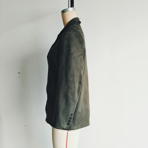 Detail of dark olive faux suede blazer featuring classic notched lapels and matte texture