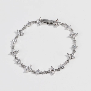 Macro view of silver four-leaf flower and marquise-cut zircon stones bracelet detail
