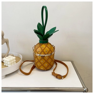 Detail of pineapple crossbody bag with yellow PU leather and silver rivet studs