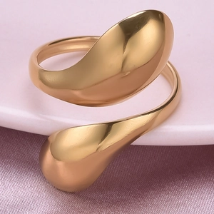 Detailed shot of gold asymmetrical fluid water drop ring on elegant silk background