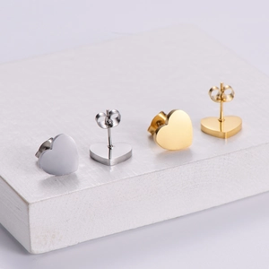 Exquisite gold and silver heart-shaped stud earrings set in a minimalist metal finish