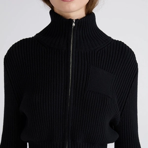 Close-up of black ribbed knit cardigan with stand collar and silver metal zipper detail