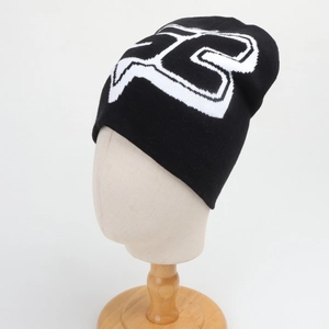 Close-up of the black knit beanie featuring a large white fox jacquard logo detail