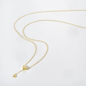 Detailed macro view of S925 hallmark on a double heart gold-plated silver necklace