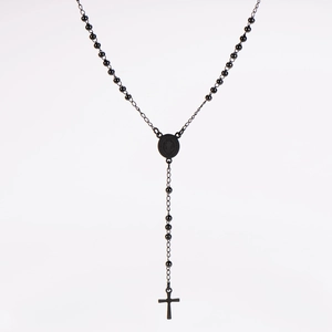 Close-up of black beaded rosary necklace featuring Saint Benedict medal and crucifix