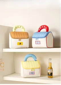 Close-up of quilted house-shaped cosmetic bags with lucky embroidery on thick handles