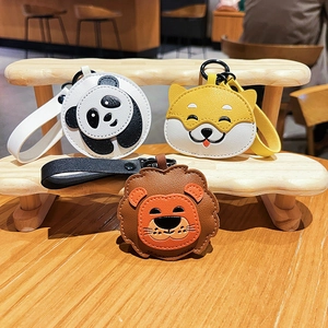 Cute leather animal keychains featuring panda, shiba inu and lion styles on wooden shelf