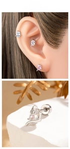 Detailed macro view of oval zircon snake earrings in blue pink and clear colors