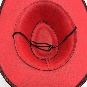 Top view of red vintage western cowboy hat with wide brim and adjustable chin strap