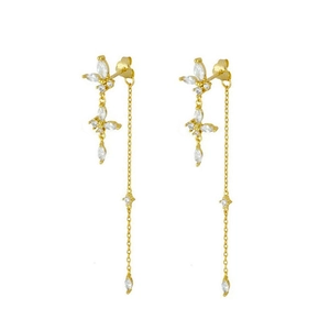 Detailed macro view of gold tassel earrings featuring marquise zircon butterfly and long chains