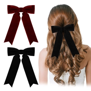 Detail of velvet oversized bow hair clips in wine red and black for women