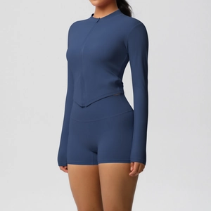 Detail of navy yoga set featuring slim fit long sleeve zip top and high waist shorts
