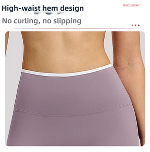 Detail of high-waist flared yoga pants featuring contrast white piping and elastic fabric