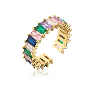 Detail of gold-plated ring with colorful rectangular cubic zirconia in a row