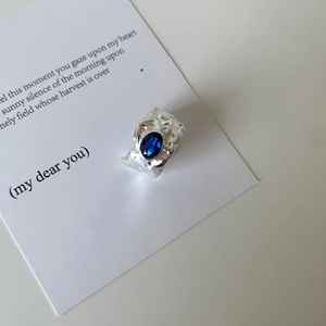 Irregular textured S925 silver ring featuring a deep blue oval gemstone on poetic card