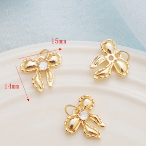 Three gold-toned 14K clover pendants with central crystals, 15mm x 14mm size detail