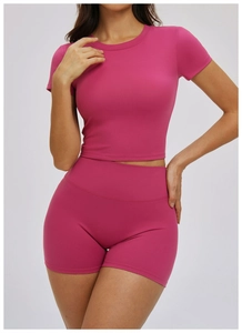 Close-up of the ribbed fabric texture on this slim fit rose red yoga crop top and shorts