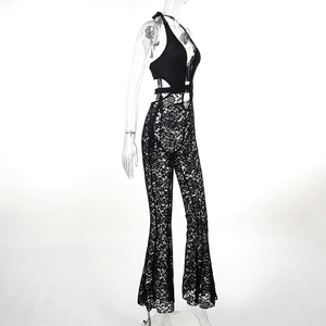 Detailed view of the sheer black lace halter jumpsuit with side cut-outs and flared legs