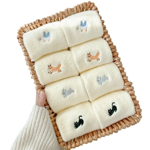 Eight pairs of warm beige thermal socks with cute animal embroidery in a woven basket