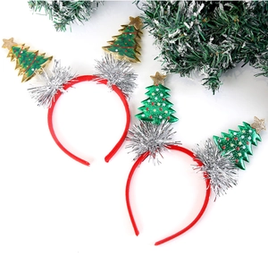 Detail of Christmas tree headbands with gold stars and festive red green ornaments