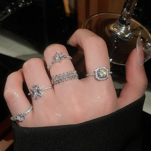 Macro view of five silver zircon rings featuring geometric heart and rectangle designs