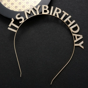 Detail of golden metal headband with glittery IT'S MY BIRTHDAY lettering for parties
