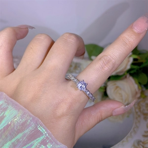 Close-up of sparkling zircon ring with main round stone and pave-set diamond details