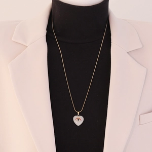 Detail view of heart-shaped natural stone necklace with eye design on a model