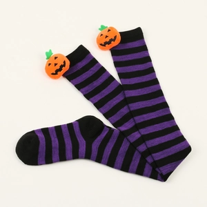 Detail of Halloween over-knee socks with purple stripes and plush pumpkin charms