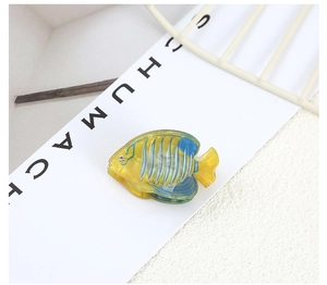 Detailed macro view of tropical fish hair clip in yellow and blue with small rhinestone eye