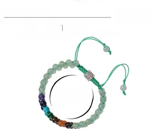 Detail of 6mm malachite beads and Tree of Life charm on a double-layer woven bracelet