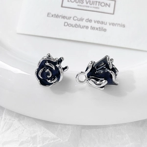 Detailed view of black rose petal metal pendants with enamel finish for jewelry making