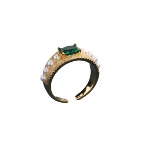 Elegant gold open ring with emerald gemstone, pearls and sparkling crystals on white base